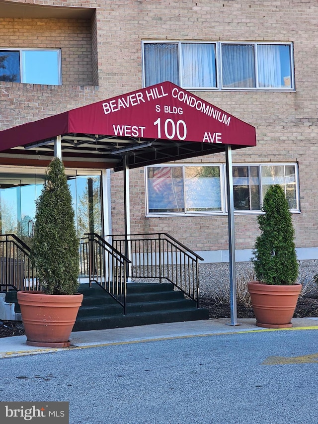100 W Ave Unit 406S, Jenkintown, PA 19046 - view of exterior entry featuring brick siding