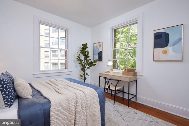 bedroom featuring wood finished floors and baseboards