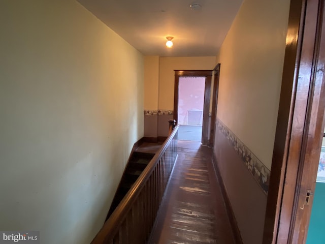 corridor featuring wood finished floors and baseboards
