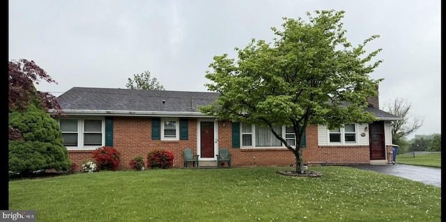 116 Sunset View Dr, New Cumberland, PA 17070 - view of front of home featuring brick siding, a front yard, a chimney, and asphalt driveway