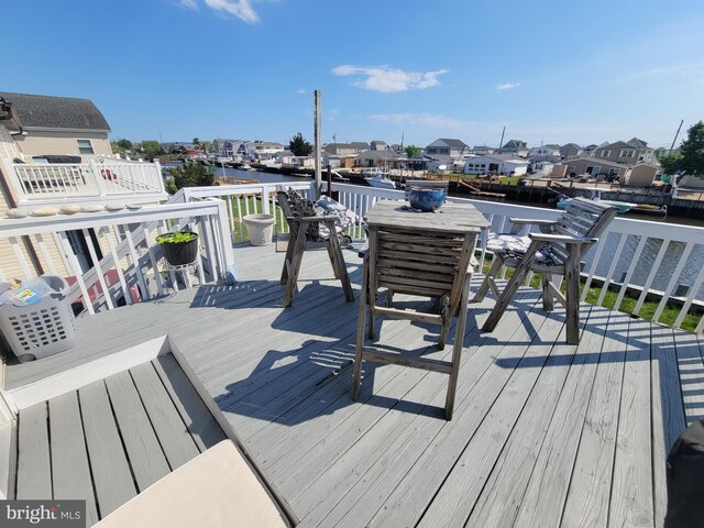 17 W Delaware Dr, Little Egg Harbor Twp, NJ 08087 - wooden terrace with a water view and outdoor dining space