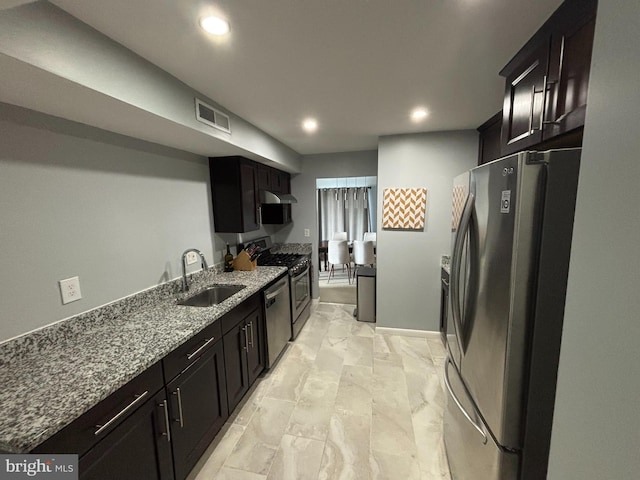 3100 S Manchester St Unit 1028, Falls Church, VA 22044 - kitchen with stainless steel appliances, a sink, recessed lighting, under cabinet range hood, and dark stone countertops
