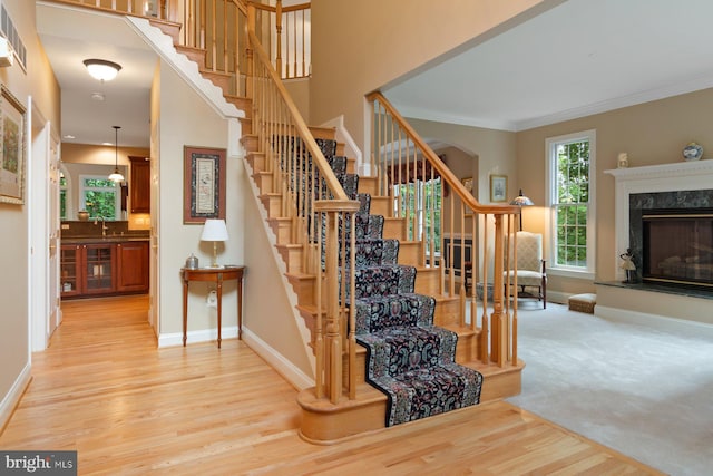 1490 Jakes Creek Dr, Woodbine, MD 21797 - stairs with wood finished floors, baseboards, ornamental molding, and a high end fireplace