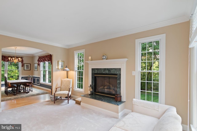 1490 Jakes Creek Dr, Woodbine, MD 21797 - living room featuring a chandelier, ornamental molding, plenty of natural light, a high end fireplace, and wood finished floors