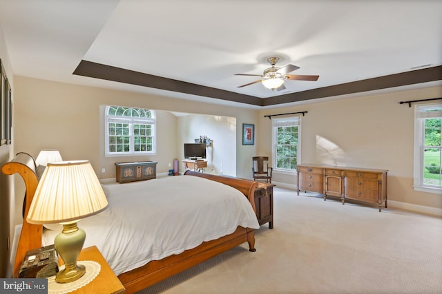 1490 Jakes Creek Dr, Woodbine, MD 21797 - carpeted bedroom featuring multiple windows, baseboards, a raised ceiling, and ceiling fan