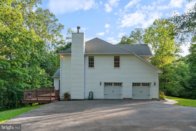 1490 Jakes Creek Dr, Woodbine, MD 21797 - view of home's exterior with asphalt driveway, a deck, a chimney, and a shingled roof