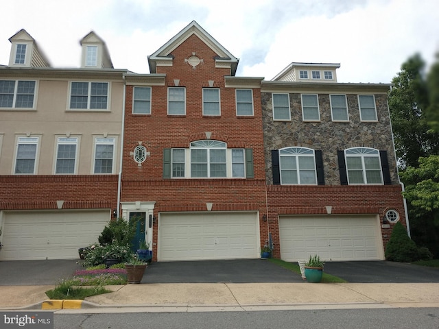 view of front facade with driveway, an attached garage, and brick siding