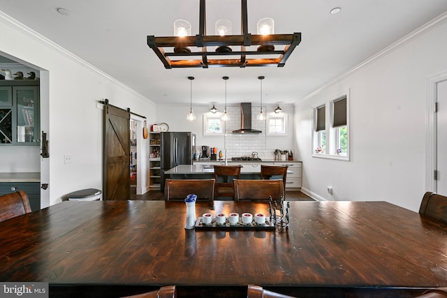 5688 Kirkpatrick Ct, Salisbury, MD 21801 - dining area featuring a barn door, crown molding, a chandelier, and dark wood-type flooring