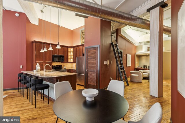 428 N 13th St Unit 3G, Philadelphia, PA 19123 - dining area with a high ceiling, light wood-style floors, track lighting, and baseboards