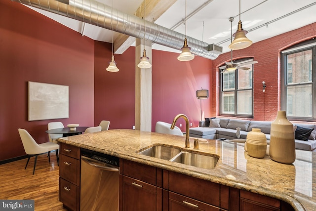 428 N 13th St Unit 3G, Philadelphia, PA 19123 - kitchen featuring a sink, wood finished floors, hanging light fixtures, light stone counters, and stainless steel dishwasher