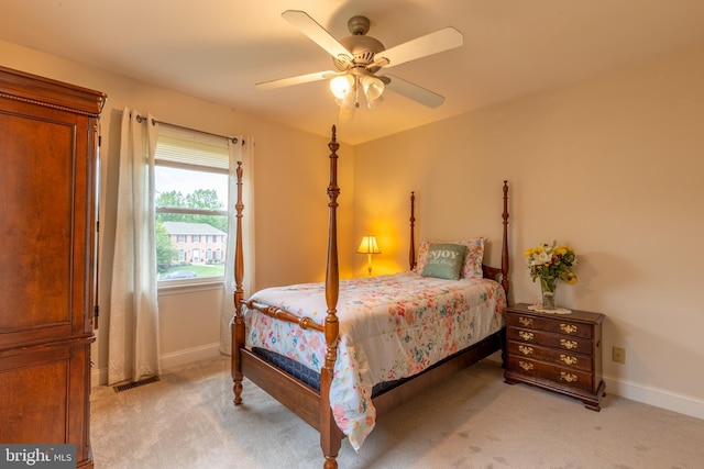 bedroom featuring light carpet, baseboards, and ceiling fan