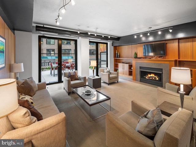1133 14th St NW Unit 1005, Washington, DC 20005 - living area with rail lighting, a tiled fireplace, and wood finished floors
