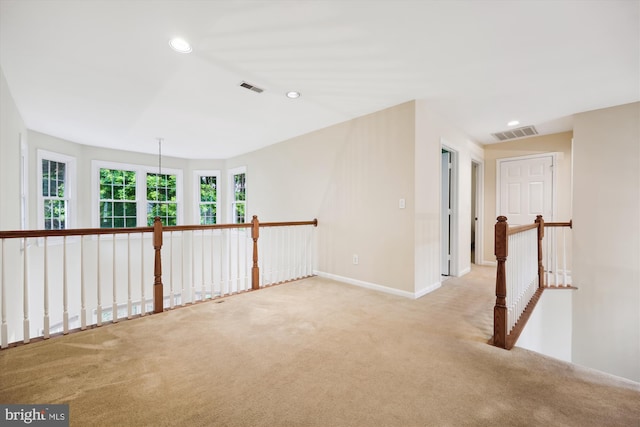 hall with an upstairs landing, carpet flooring, recessed lighting, and baseboards