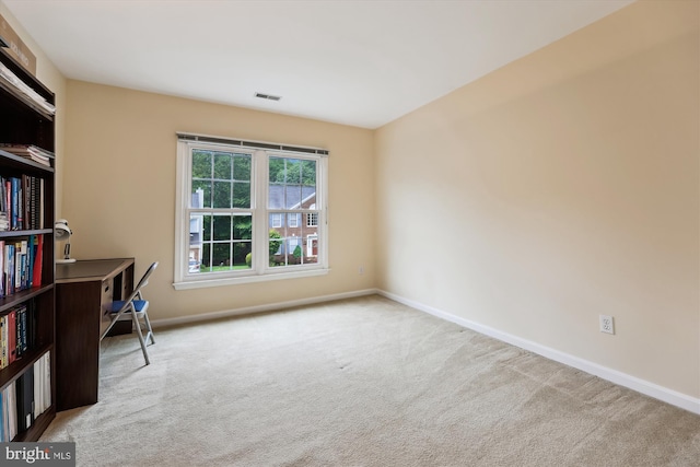carpeted spare room with baseboards