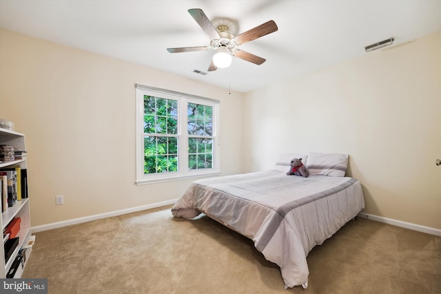 bedroom with baseboards, light colored carpet, and ceiling fan