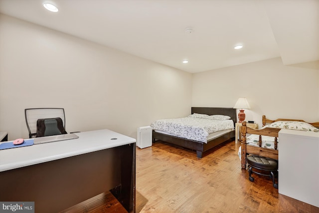 bedroom featuring recessed lighting, light wood finished floors, and an office area