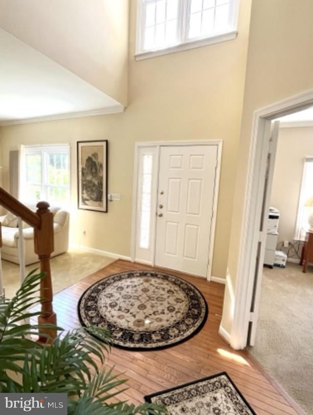 18717 Severn Rd, Gaithersburg, MD 20879 - foyer featuring a towering ceiling, baseboards, wood finished floors, and stairway