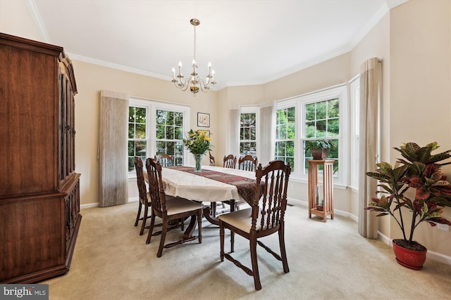 dining room with a chandelier, light carpet, ornamental molding, and baseboards