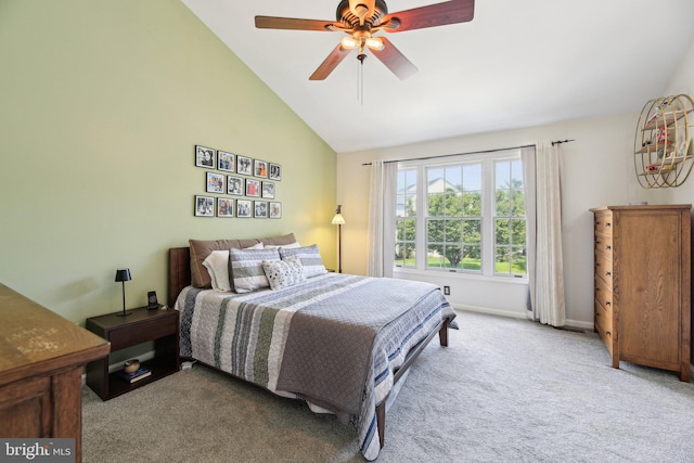 carpeted bedroom featuring vaulted ceiling, ceiling fan, and baseboards