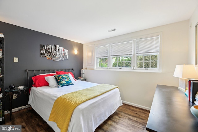 bedroom featuring wood finished floors and baseboards