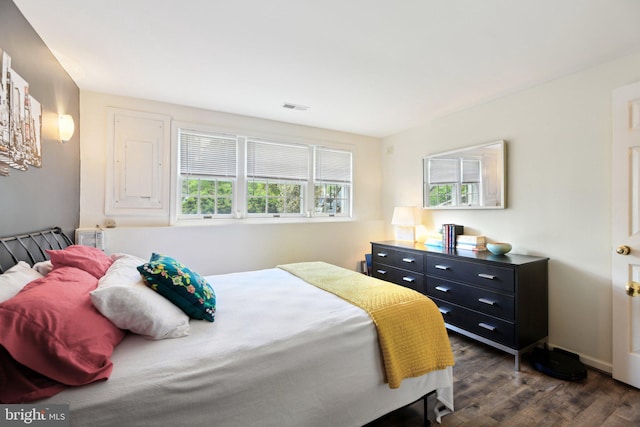 bedroom featuring dark wood-style floors and baseboards