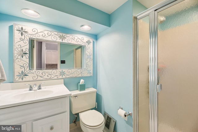 bathroom with a stall shower, toilet, vanity, and heating unit