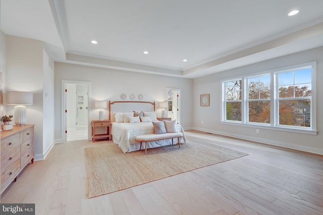bedroom featuring light wood-style floors, a raised ceiling, baseboards, and recessed lighting