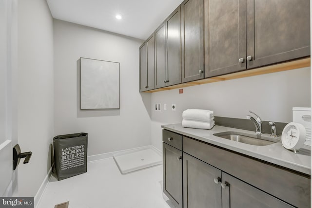 clothes washing area featuring cabinet space, washer hookup, recessed lighting, and hookup for an electric dryer