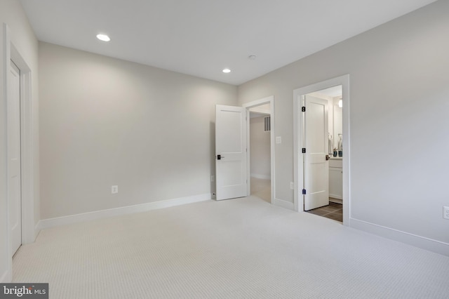 unfurnished bedroom featuring carpet, baseboards, and recessed lighting
