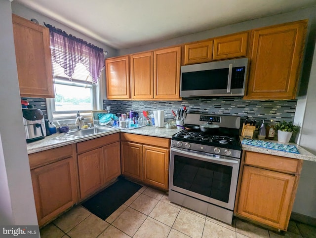 1102 S Merrimac Rd, Camden, NJ 08104 - kitchen with stainless steel appliances, decorative backsplash, and light countertops