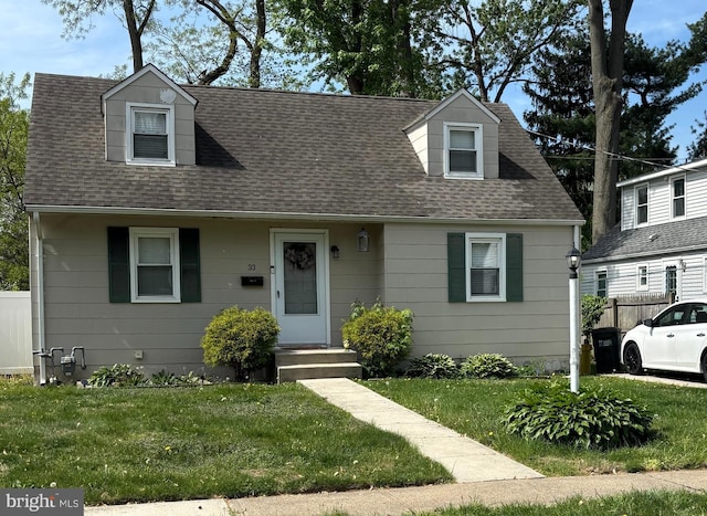 new england style home with a shingled roof