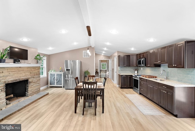 83 Ridge Crest Dr, Harpers Ferry, WV 25425 - kitchen featuring appliances with stainless steel finishes, a sink, dark brown cabinetry, light wood finished floors, and decorative backsplash