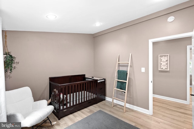 83 Ridge Crest Dr, Harpers Ferry, WV 25425 - bedroom featuring wood finished floors, baseboards, recessed lighting, and a nursery area