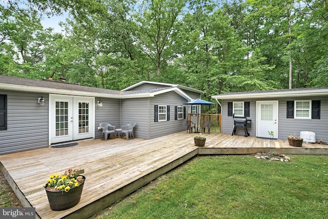 83 Ridge Crest Dr, Harpers Ferry, WV 25425 - wooden deck with french doors, a yard, and view of scattered trees