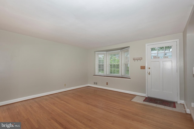 entrance foyer featuring light wood-style flooring and baseboards