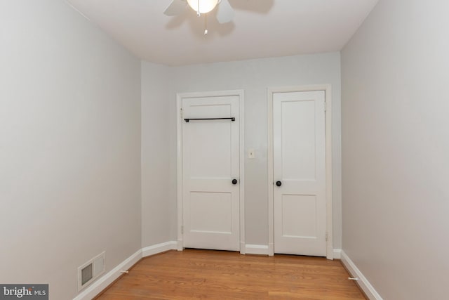 unfurnished bedroom with light wood-style flooring and baseboards