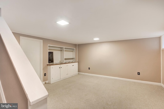 finished basement featuring light colored carpet, baseboards, and recessed lighting