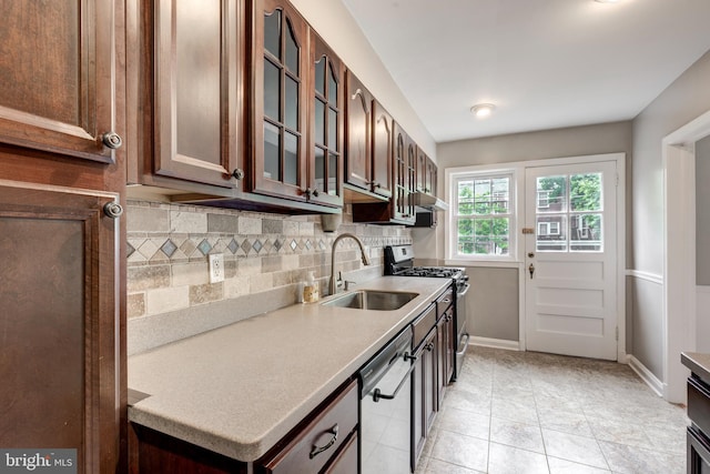 kitchen with stainless steel gas stove, dishwashing machine, a sink, tasteful backsplash, and light countertops