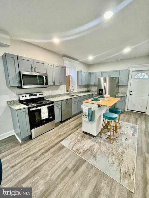 263 S Hilton St, Baltimore, MD 21229 - kitchen featuring appliances with stainless steel finishes, a sink, light countertops, light wood-style floors, and recessed lighting