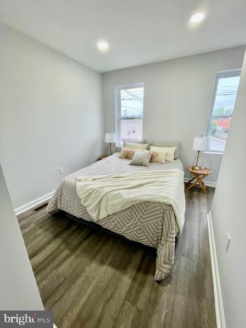 263 S Hilton St, Baltimore, MD 21229 - bedroom featuring wood finished floors, multiple windows, baseboards, and recessed lighting