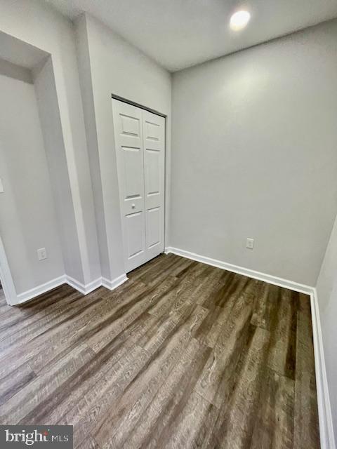 263 S Hilton St, Baltimore, MD 21229 - unfurnished room with dark wood-style flooring and baseboards