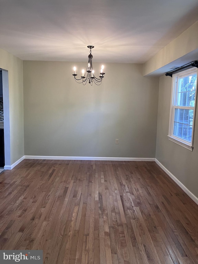 9118 Bobwhite Cir, Gaithersburg, MD 20879 - unfurnished room with dark wood-style flooring, a chandelier, and baseboards