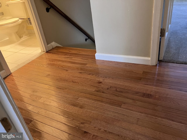 9118 Bobwhite Cir, Gaithersburg, MD 20879 - detailed view of toilet, wood finished floors, and baseboards