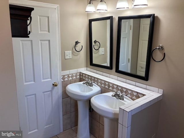 9118 Bobwhite Cir, Gaithersburg, MD 20879 - bathroom featuring tile walls and a sink