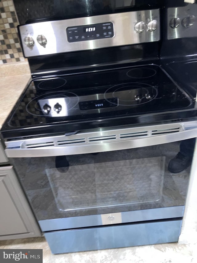 9118 Bobwhite Cir, Gaithersburg, MD 20879 - kitchen view of stainless steel electric range and decorative backsplash