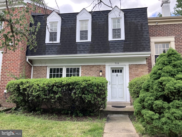 9118 Bobwhite Cir, Gaithersburg, MD 20879 - view of front of property with mansard roof, a shingled roof, and brick siding