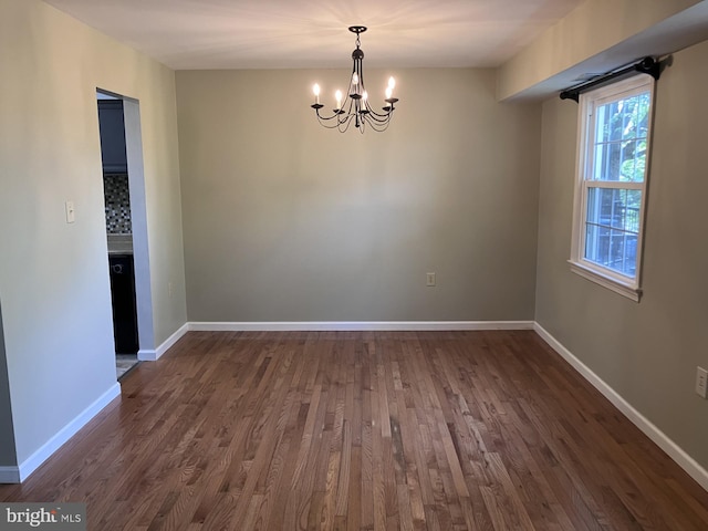 9118 Bobwhite Cir, Gaithersburg, MD 20879 - spare room with a chandelier, dark wood-type flooring, and baseboards