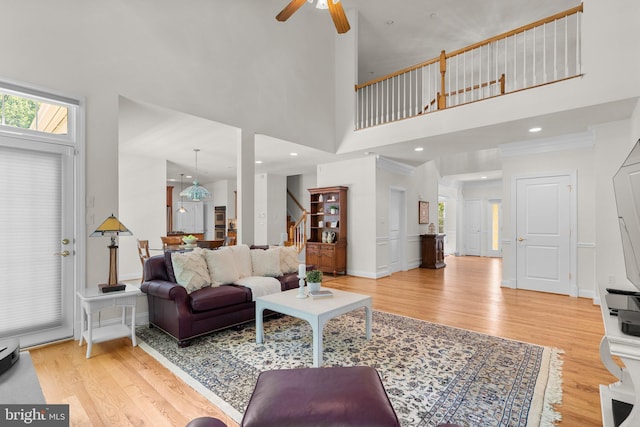 301 Reserve Gate Ter, Silver Spring, MD 20905 - living room with light wood-style floors, a towering ceiling, stairway, and healthy amount of natural light