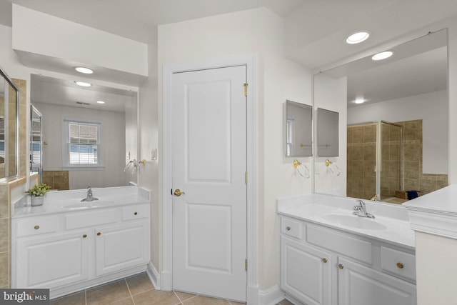 301 Reserve Gate Ter, Silver Spring, MD 20905 - bathroom with two vanities, tile patterned flooring, recessed lighting, tiled shower, and baseboards