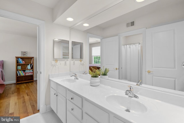 301 Reserve Gate Ter, Silver Spring, MD 20905 - full bath with double vanity, baseboards, recessed lighting, and wood finished floors